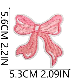 Pink embroidered bow patch with size dimensions showing 5.6cm height and 5.3cm width