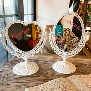 European vintage style desktop makeup mirror with white embossed frame and swivel base