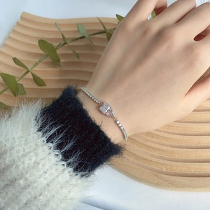 Close-up of S925 silver tennis bracelet with pink heart and clear square zircon stones