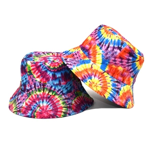 Macro detail of vibrant tie-dye bucket hats with rainbow pattern and flat top design