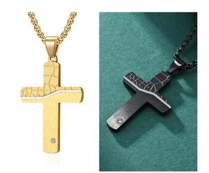 Detail of cross pendant featuring gold and black cracked texture with a small diamond inlay