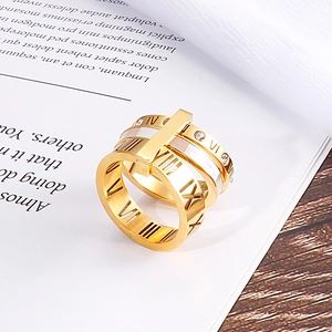 Detailed shot of a gold Roman numeral ring with crystals on an open book page