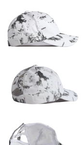 Detail of black and white tie-dye cotton baseball cap with criss-cross elastic ponytail hole