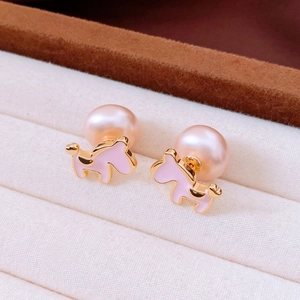 Detailed close-up of pink enamel puppy stud earrings with lustrous round pearls