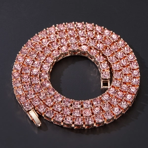 Detailed macro view of rose gold tennis chain with pink rhinestones and secure clasp