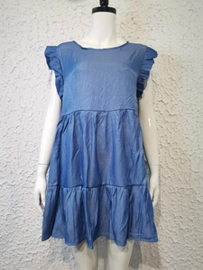 Detail of blue crew neck mini dress showing layered ruffle sleeves and pleated hemline