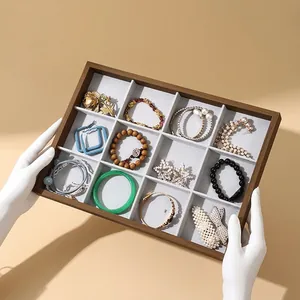 12-compartment walnut grain jewelry tray with grey velvet lining for rings and bracelets