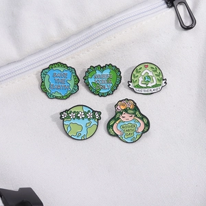 Set of 5 eco-friendly enamel pins with green earth and flower designs on canvas