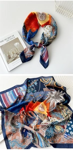 Detail of vibrant sun totem silk scarf featuring tropical leaves and geometric patterns