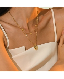 Detail of 14K gold double-layer necklace with multicolor heart pendant on female model