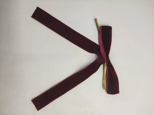 Detail of burgundy velvet Christmas bow with gold wire for gift box and tree decoration