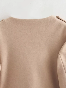 Close-up of beige wool jacket collar and shoulder with high-quality fabric texture