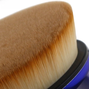 Macro close-up of high-density synthetic fiber bristles on an oval foundation brush