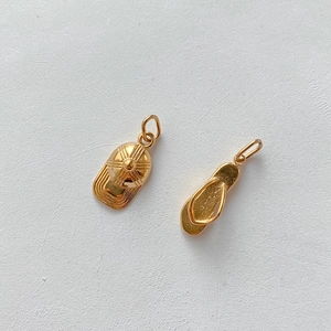 Detailansicht der goldenen Anhänger in Form von Kappe und Flip-Flop für DIY-Schmuck