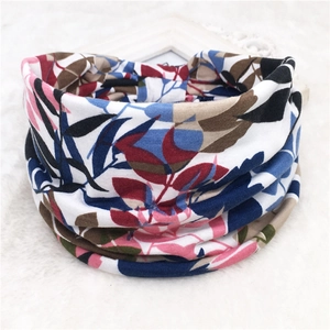 Detail view of floral print sports headband on soft white plush texture background