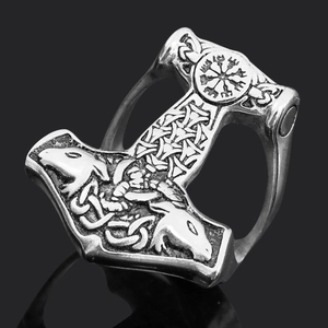 Detailed macro shot of Viking Mjölnir ring with Norse runes on black reflective background