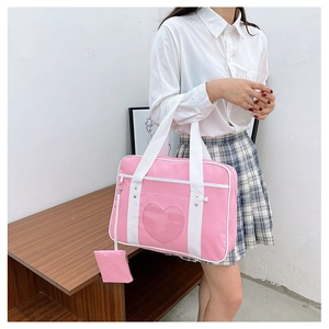 Pink JK uniform ITA bag with heart-shaped transparent window and matching coin purse