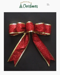 Detail of red Christmas bow with gold glitter edges on a black background