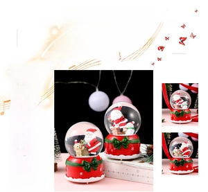 Detail of Christmas crystal ball music box with Santa and snowman figurines in glitter
