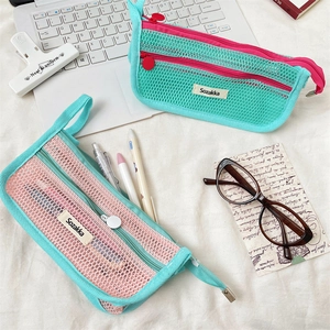 Detail of dual-zipper mesh pencil cases in mint green showing breathable nylon texture