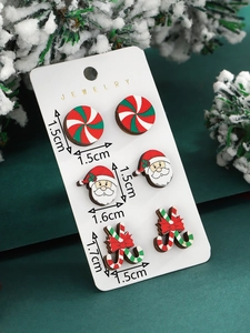Detail view of wooden Christmas studs set with size specs on festive display card