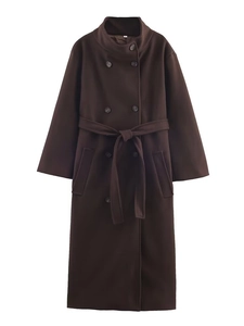 Detail of dark brown double-breasted long coat with waist belt and wool texture
