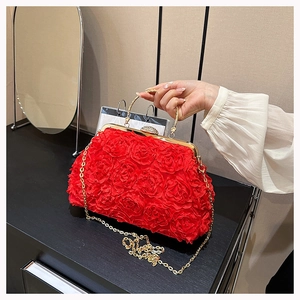 Detail of red floral evening bag with 3D roses, gold metal handle and chain strap