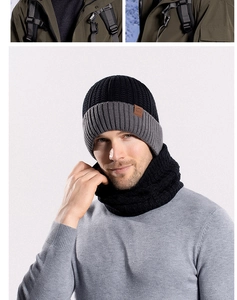 Detail of winter knit beanie and neck warmer set showing texture and leather logo