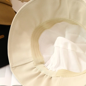 Beige bucket hat with soft lining and sweatband shown in a high-quality interior view