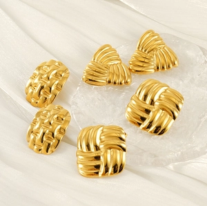 Macro detail of 18k gold plated stainless steel earrings with geometric woven patterns