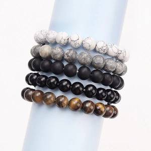 Set of five natural stone beaded bracelets including tiger eye and onyx on blue stand
