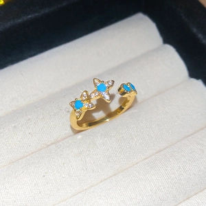 Close-up of 18k gold plated star ring with turquoise center and micro-pave zircons