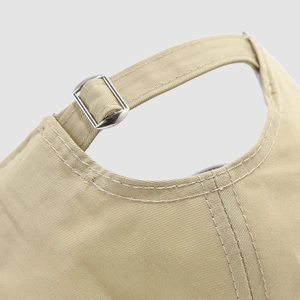 Detail of adjustable metal buckle and khaki cotton twill fabric on kids baseball cap