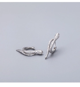 Detailed view of silver snake-shaped earrings encrusted with micro white zircon stones