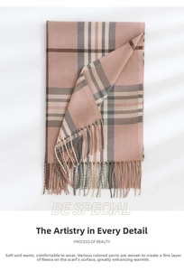 Detail shot of soft cashmere-feel pink plaid scarf featuring delicate fringed edges