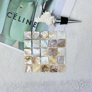 Detail of square mosaic shell coaster with natural mother-of-pearl iridescent texture
