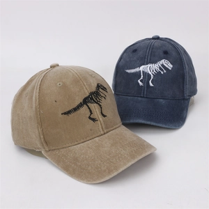 Detail of washed cotton baseball caps with dinosaur skeleton embroidery in khaki and navy