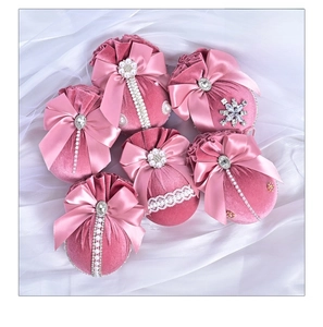 Detail of pink velvet Christmas balls with satin bows, pearls and crystal rhinestones