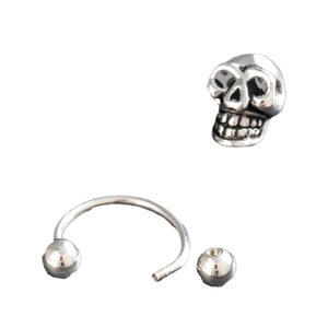 Retro stainless steel horseshoe skull earring featuring a minimalist vintage punk design