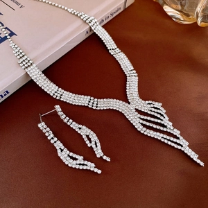 Macro shot of silver tassel necklace and earrings set with sparkling rhinestones