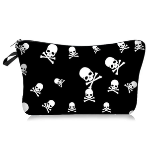 Detail view of the Halloween makeup bag featuring white skull prints and a black wristlet strap