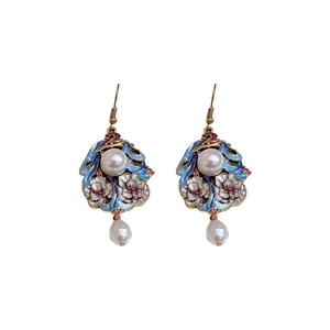 Vintage enamel earrings with flower patterns, pearls and pink gems on white background