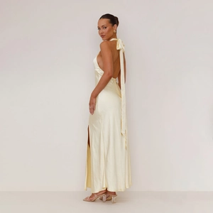 Detailed back view of satin halter maxi dress featuring backless design and high side slit