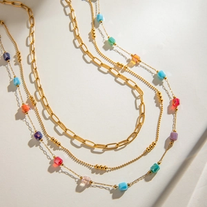 Minimalist layered stainless steel necklace featuring gold chains and colorful square glass gems