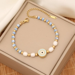 Evil eye beaded bracelet with gold accents and pearls on a premium jewelry box display
