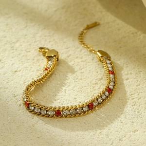 Detail of gold bracelet with alternating red and white zircons and adjustable chain