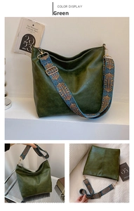 Detail of dark green vintage hobo bag featuring ethnic embroidered wide strap and matte leather