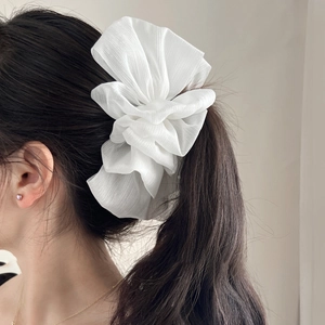 Elegant white pleated chiffon scrunchie shown on a ponytail with floral aesthetic