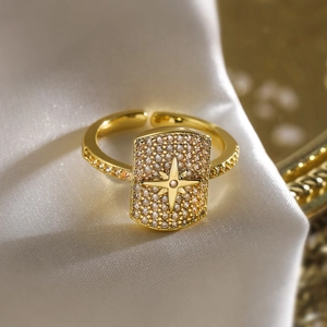 Luxury gold plated open ring with an octagon star zircon design on beige silk