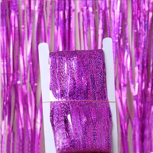 Detail of laser purple tinsel curtain showing the reflective foil fringe on card packaging